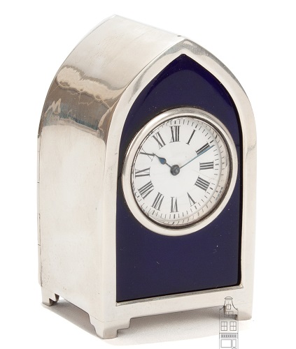 A small English sterling silver travel clock with blue enamel, circa 1896.